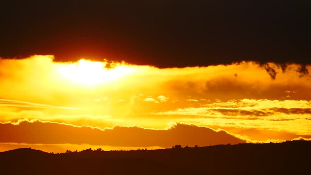 Skyscape. Burning sky, dark stormy clouds. Red orange color sunset over sea. Nature, coastal landscape. Capi Corb, Mediterranean coast of Spain.