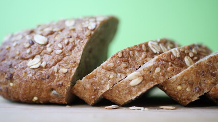 Slicing Whole Grain Bread On Wooden Table.