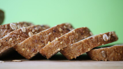 Slicing Whole Grain Bread On Wooden Table.