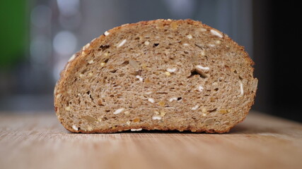 Slicing Whole Grain Bread On Wooden Table.