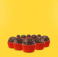 Brazilian traditional sweet isolated on yellow background. Handmade "Brigadeiro"