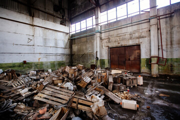 Abandoned large industrial hall with garbage waiting for demolition