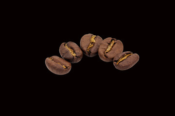 Roasted coffee beans, close-up. Coffee bean isolated on black