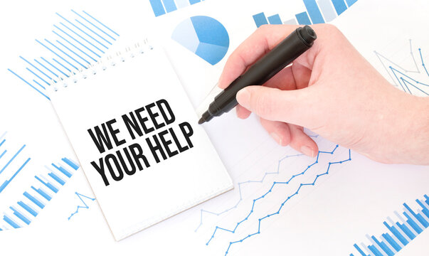 Businessman holding a black marker, notepad with text we need your help ,business concept