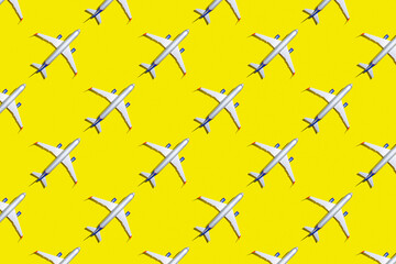 Travel and vacation concept. Top view of plane on bright yellow color background pattern. Mockup for travel project.