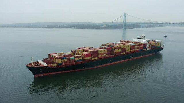 flying clockwise around container ship in front of Verrazzano Bridge near NYC