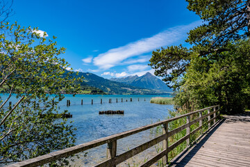 Naklejka na ściany i meble Wooden bridge with a view of the lake and mountains - Interlaken, Switzerland