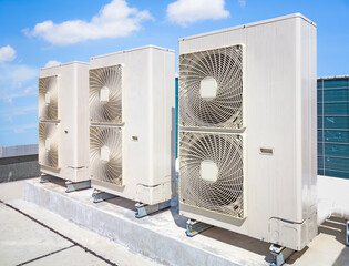 Condenser unit or compressor on roof of industrial plant building with sky background. Unit of...