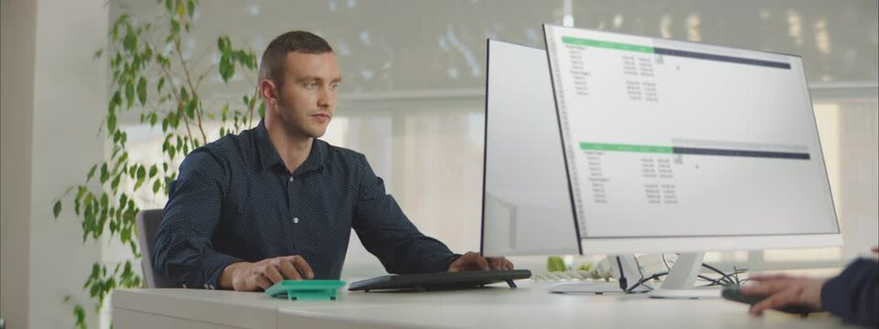 Office Workers working on Gantt chart schedule to create planning with tasks and milestones to plan activities. Person working with management tools on computer in office.
