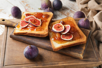 Tasty toasted bread with sweet fig jam on table