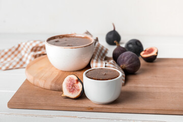 Bowls of sweet fig jam on white table