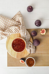 Bowls of sweet fig jam on white table