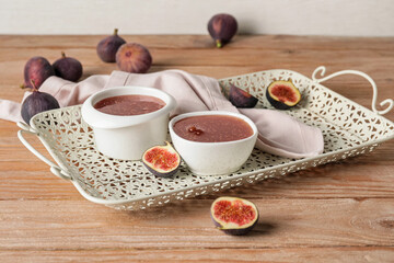 Bowls of sweet fig jam on wooden table
