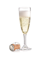 Glass of champagne and cork on white background
