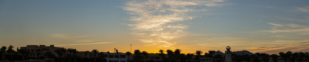 Sunset on the sea coast. The movement of clouds in the sky. Evening turns to night.