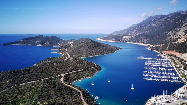 The top view from the drone of Kas resorts and city with amazing blue and clear lagoon and yachts in Mugla province of Turkey