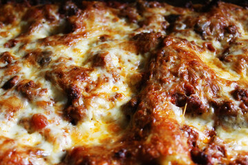 Close-up of a pizza, with melted cheese and pepperoni.