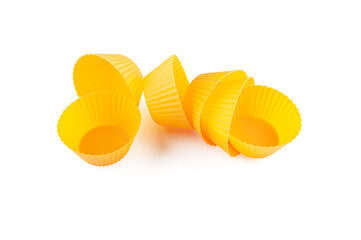 Orange yellow silicone forms for cooking muffin and cupcake isolated on white. The muffin moulds for baking.