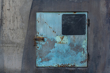 Old rusty door on side of abandoned wheat silo in the countyside
