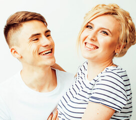 young pretty teenage couple, hipster guy with his girlfriend happy smiling and hugging isolated on...