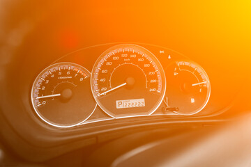 dashboard of the car is illuminated by bright illumination. Speedometer, circle tachometer, oil and...