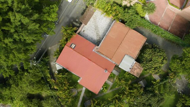 Top Down View of Private Home Surrounded by Lush Greenery and Vegetation. Pedestal Down