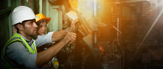 Mechanical engineers and assistants repairing industrial machines.