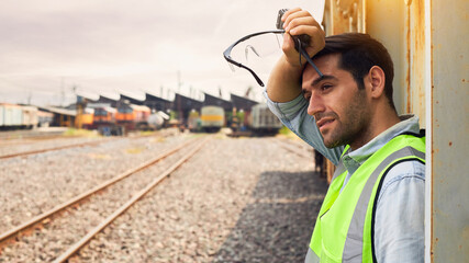 Railway Industry Engineer standing beside the Freight Train.