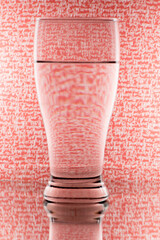 refraction of light by a glass on a red and white background. Abstract glass art.