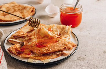 Homemade crepes with sea buckthorn jam and milk.