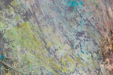 colorful creative motley background: smudged residues of oil paints on a wooden palette, short focus, selective blur