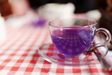 Cup tea of viola flowers, cinnamon and ginger. selective focus