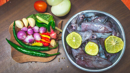 cuttlefish and spices on the cuttingboard. Preparation before cooking calamari