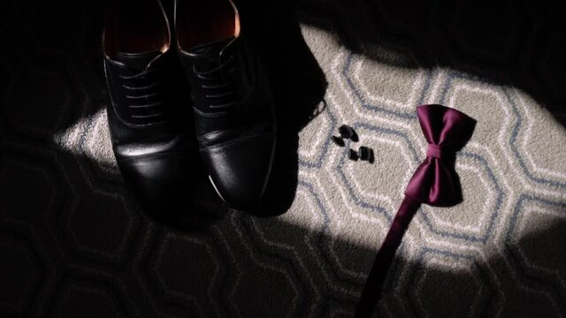 Men's suit - black shoes, bow tie, cufflinks. Accessories for the groom wedding fashion. High quality FullHD footage