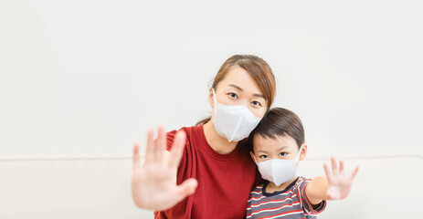 Coronavirus Covid19.Online education at home.Asian mother and boy child kid wearing face mask stop covid19.Homeschool kid.Online learning.Stay home.Social distancing.New normal.Mask, post covid life.
