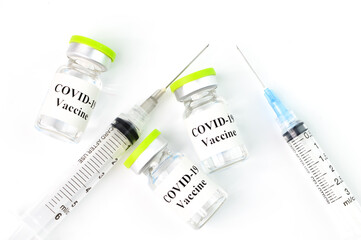 yringe and Covid-19 bottle vaccination over white background.