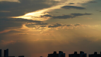 Fototapeta premium The beautiful sunset view with the round sun and the colorful clouds in the sky