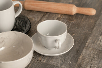 cups, kitchen utensils, rolling pin, on the kitchen table