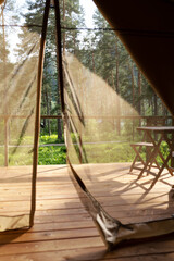 View from the glamping tent on the table and chairs on the terrace