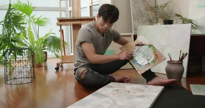 Young Chinese man painting at home,4K
