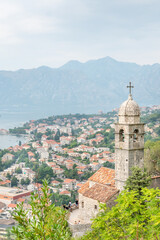 Fototapeta na wymiar Church of Our Lady of Remedy with Old Town in the background, Kotor, Montenegro.