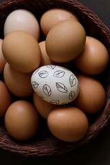 Easter eggs. White Easter with a pattern on a background of brown eggs.