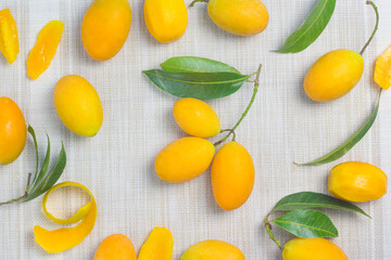 Maprang Yellow orange fruit With a sweet and sour taste mixed with appetizing, spread on the cloth floor