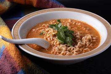 Mama Tom Yum Soup in a Cup on Black Background