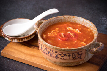 Tomato Soup with Chicken in a Cup on a Black Table