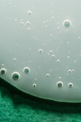 A drop of shampoo on a green background