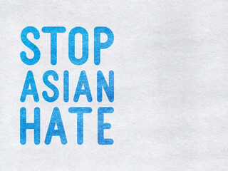 Stop Asian Hate - word on a grey textured background