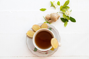 herbal drinks ginger health care sore throat with flowers jasmine arrangement flat lay style on background white wooden