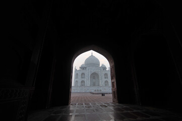 view of taj mahal from an marble arch frame.