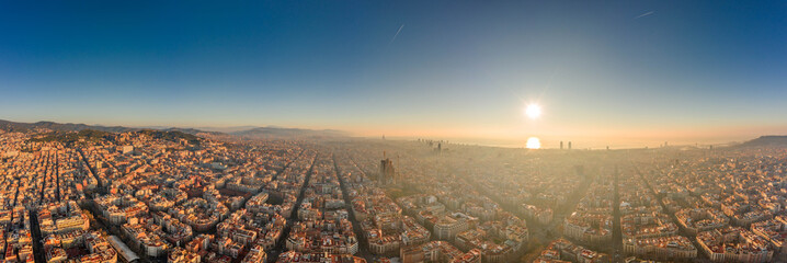 360 aerial panorama drone shot of skyline in Barcelona city center in foggy sunrise golden hour in Spain winter - obrazy, fototapety, plakaty